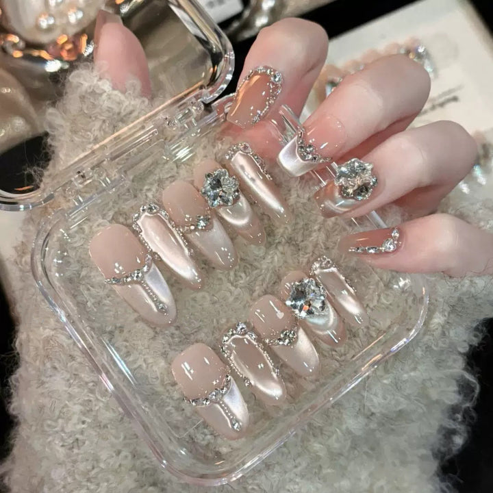 Glamorous nail tips with rhinestone and glitter effects Stornfield