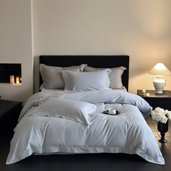 Luxurious cotton satin bedding set with monogram embroidery and fine piping