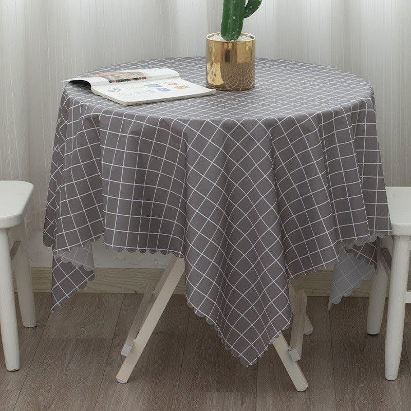 Round washable tablecloth with fine checkered grid pattern and wavy hem