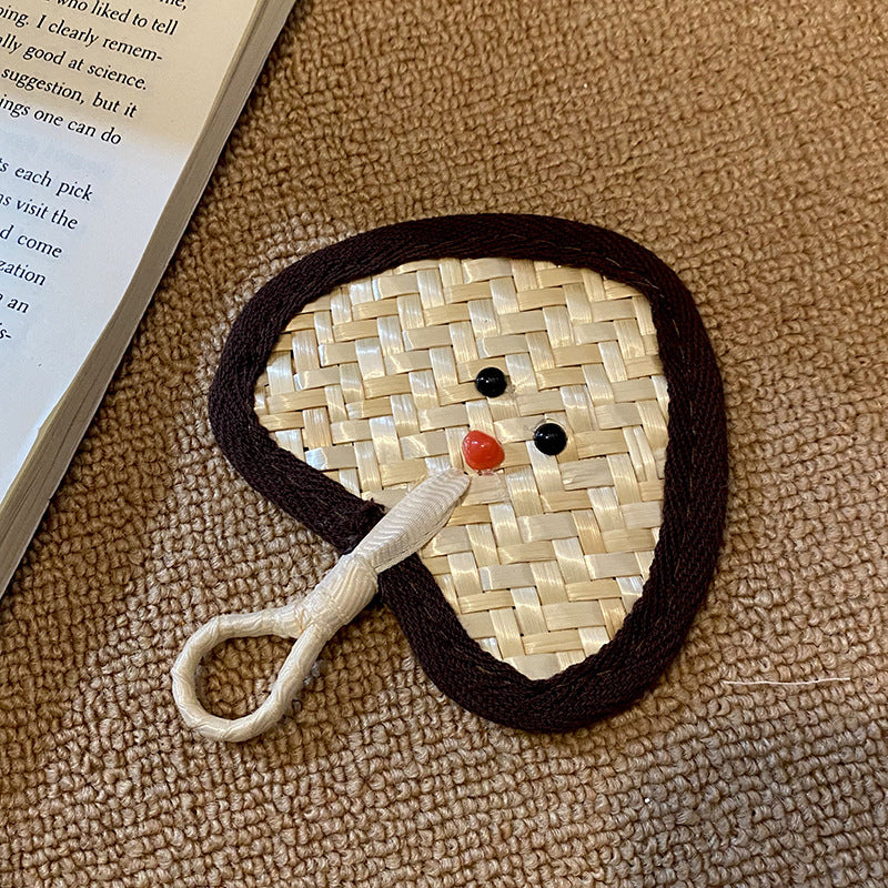 Handcrafted fan with playful face motif Stornfield
