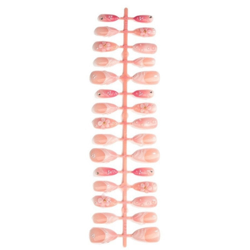 Artificial nail set with delicate floral and glitter accents Stornfield