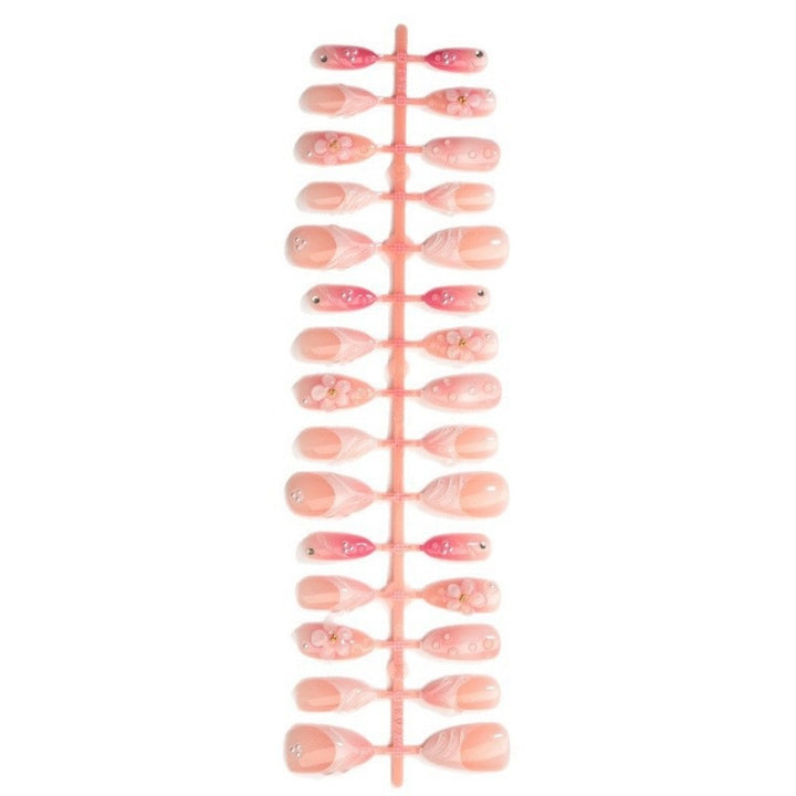 Artificial nail set with delicate floral and glitter accents Stornfield