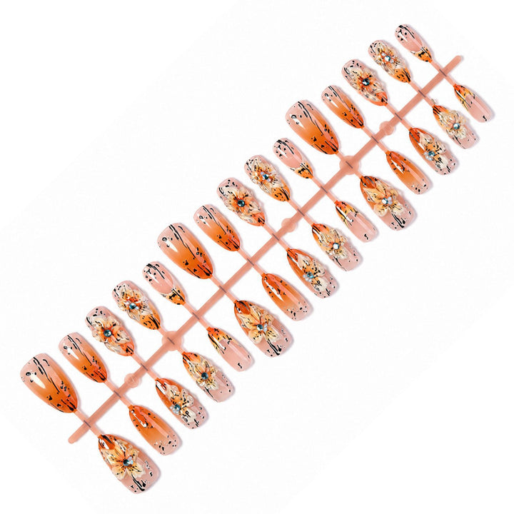 Artificial nail set with elegant floral design and sophisticated glitter elements Stornfield