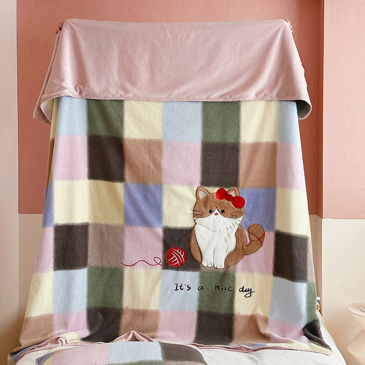 Plaid blanket checkered with appliqued animal motifs and soft velour lining