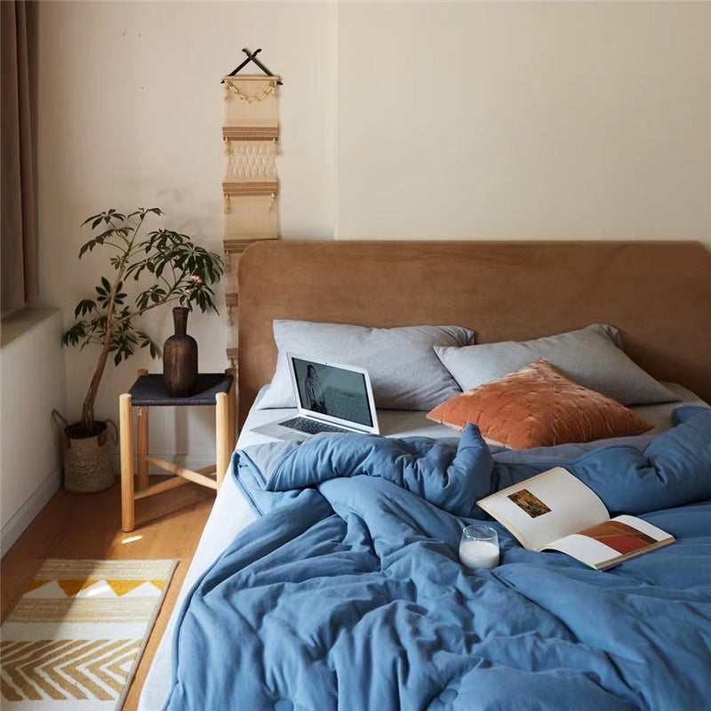 Light reversible quilted blanket made of microfiber with soft decorative stitching