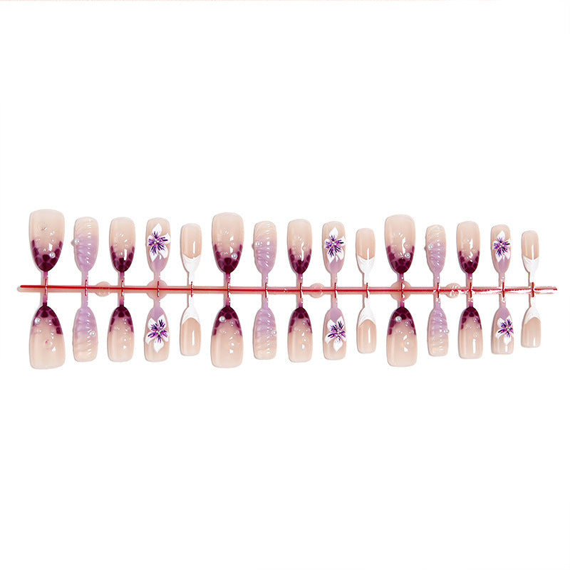 Artificial nails with elegant ombre effects and floral accents Stornfield