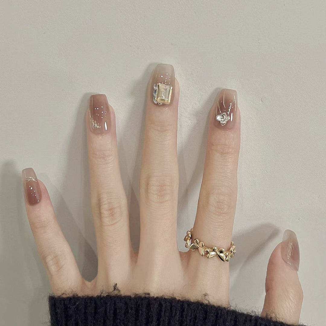 Artificial nail art with elegant jewelry accents Stornfield