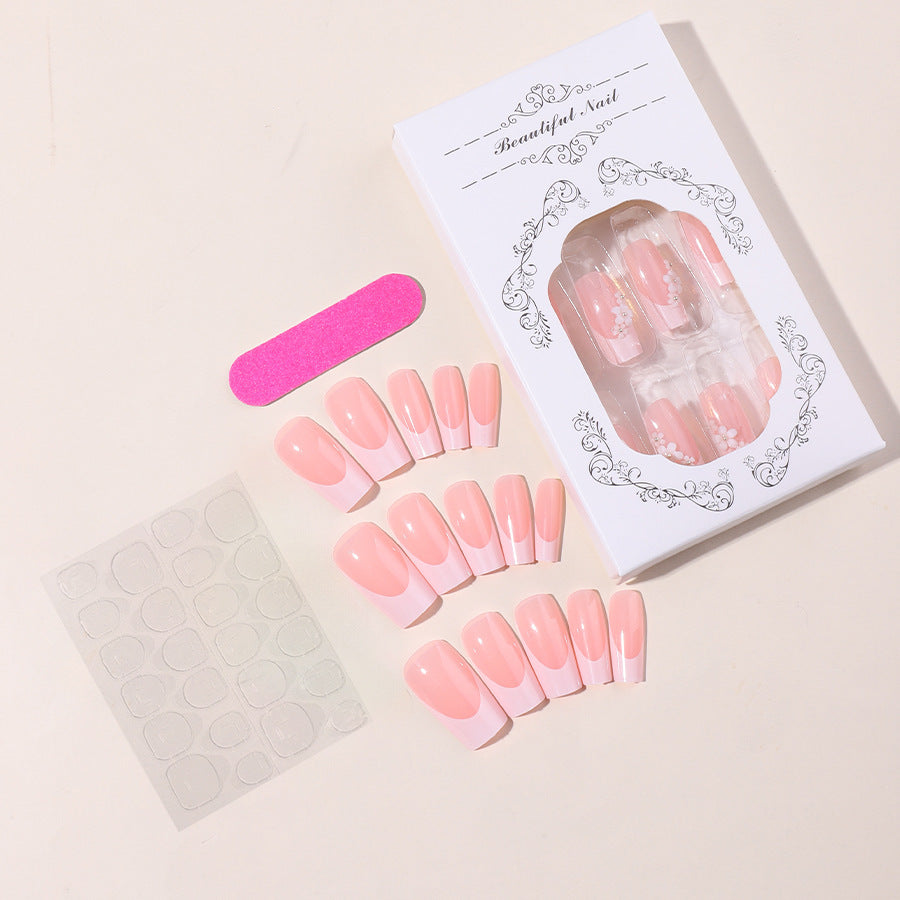 Artificial nail set with elegant French tips and hand-drawn flower motifs Stornfield