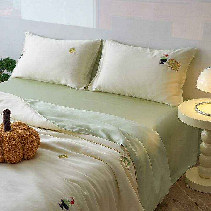 Reversible cotton satin bedding set with fitted sheet and subtle embroidery appliqués