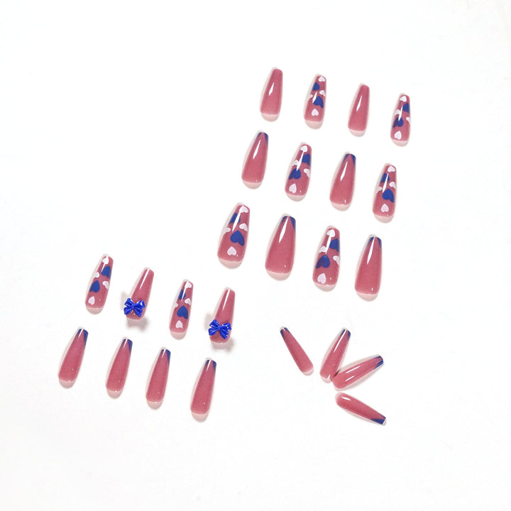 Artful stiletto nails with modern heart and bow motifs Stornfield