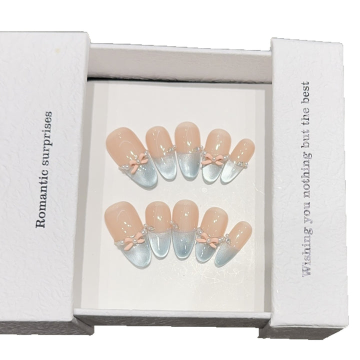 Artificial nail set with romantic bow and glitter accents Stornfield