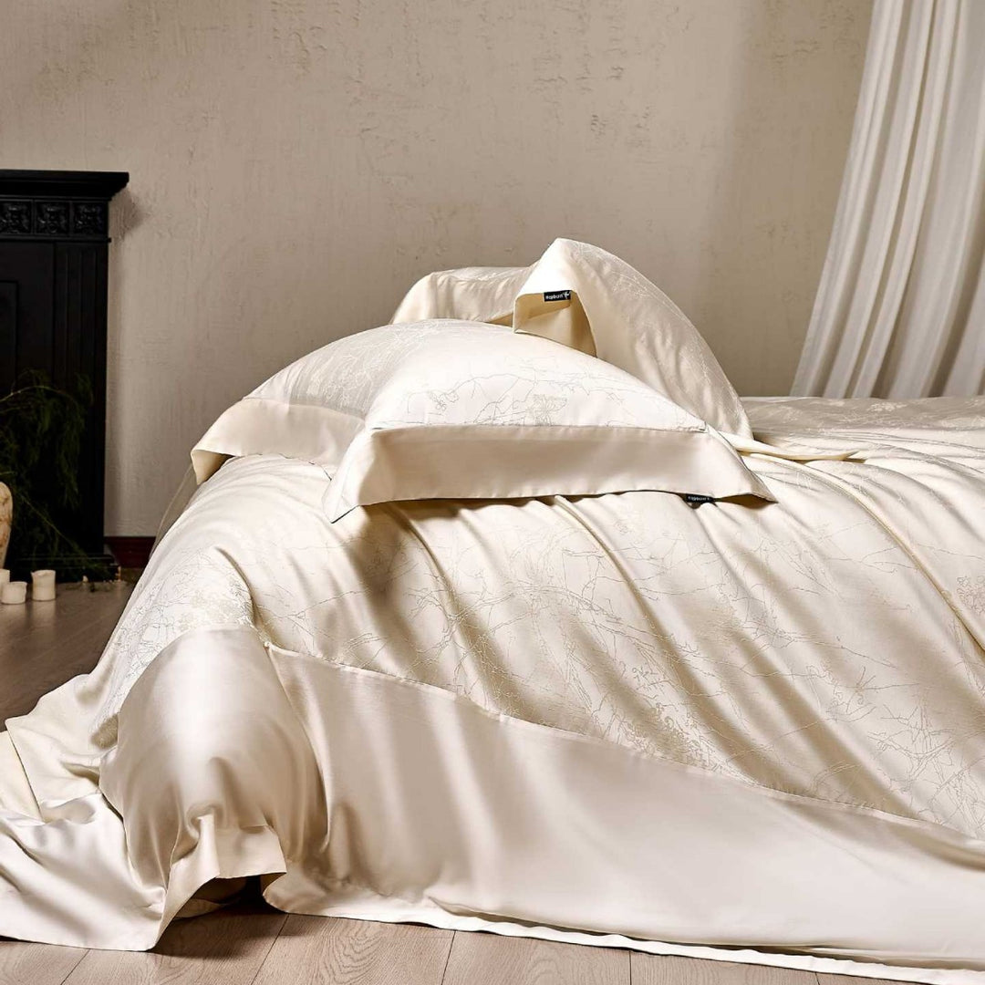 Satin bed linen set with floral jacquard texture and fine hem detail