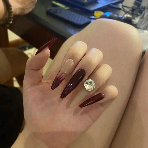 Elegant Stiletto Nail Enhancements with Gem Accents Stornfield