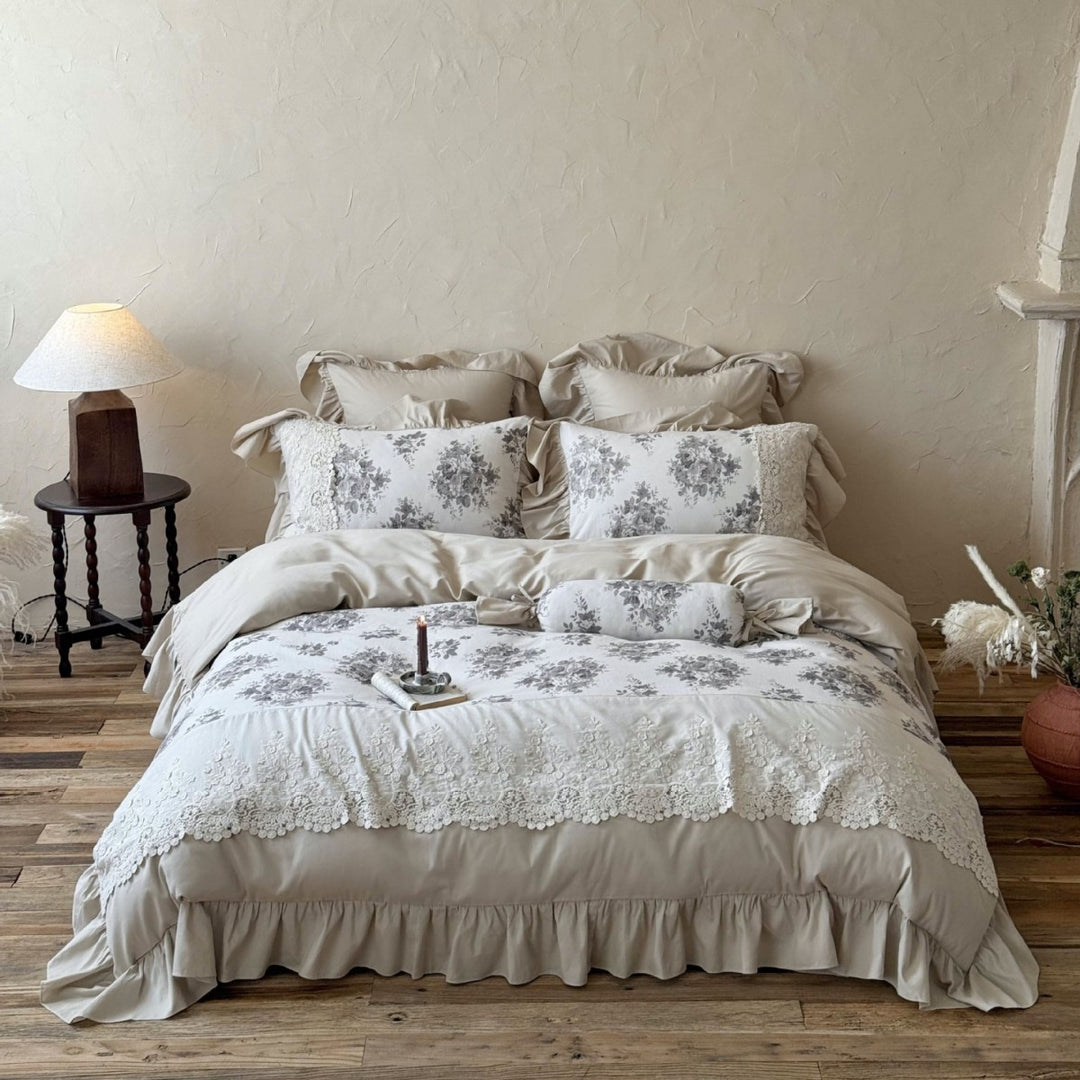 Bedding set in French country house style with lace trim, ruffled bed skirt, and subtle toile floral design