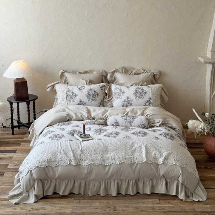 Bedding set in French country house style with lace trim, ruffled bed skirt, and subtle toile floral design