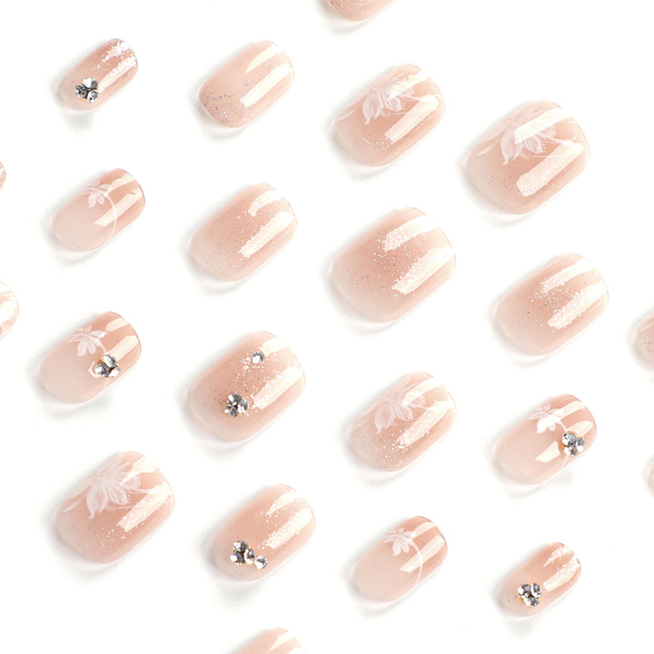 Elegant Nail Art with Holographic Accents and Floral Embellishments Stornfield