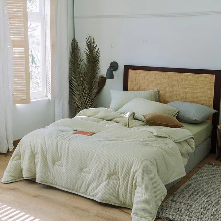 Light reversible quilted blanket made of microfiber with soft decorative stitching