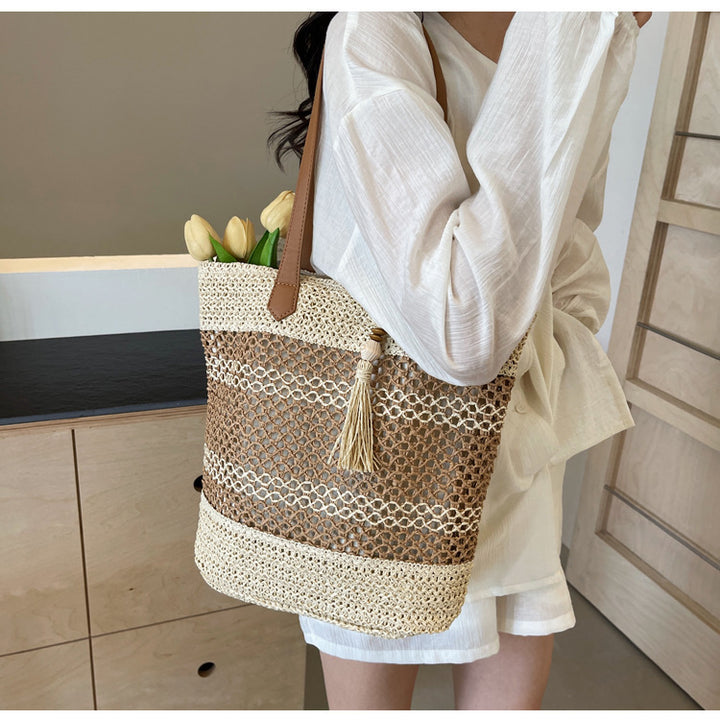 Handbag made of woven natural material with playful tassel detail Stornfield