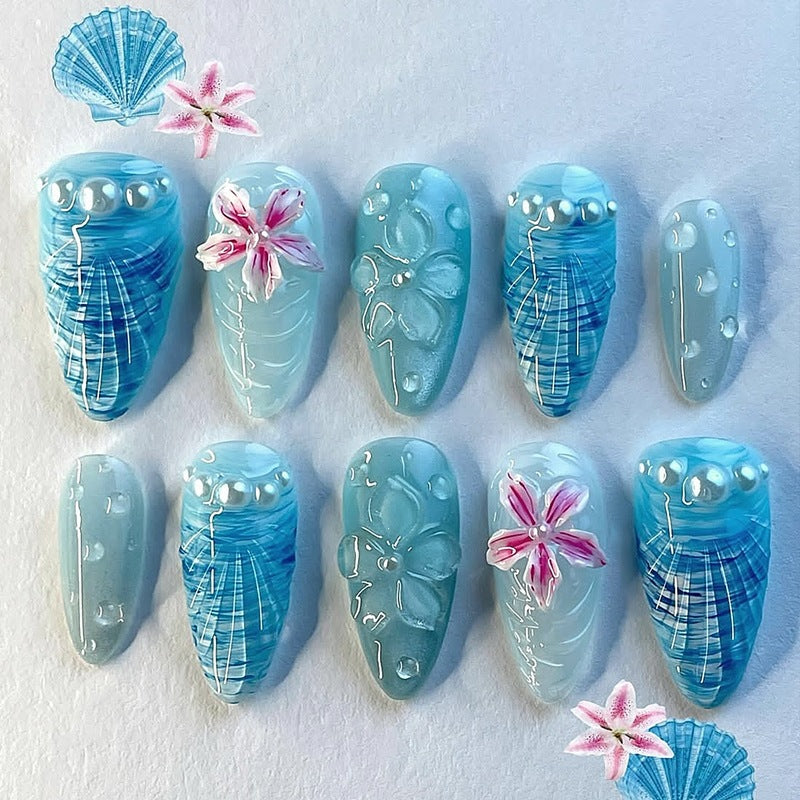 Nail art set with unique aquatic motifs and decorative accents Stornfield
