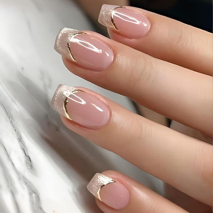 Artificial nail set with elegant glitter French tips and golden embellishments Stornfield