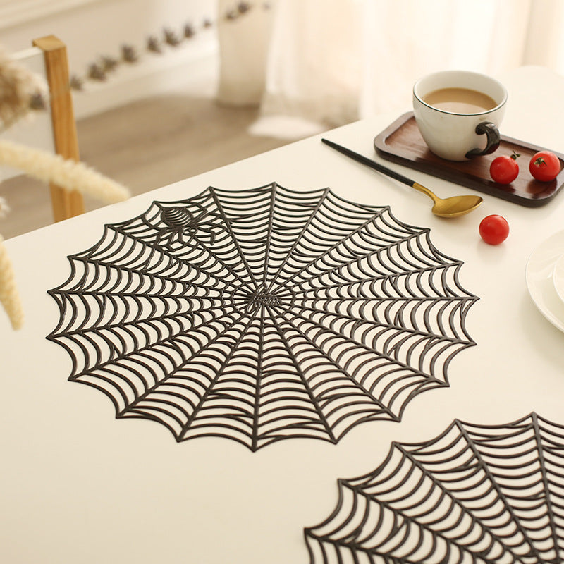 Round filigree spider web placemat made of heat- and water-repellent PVC for table decoration