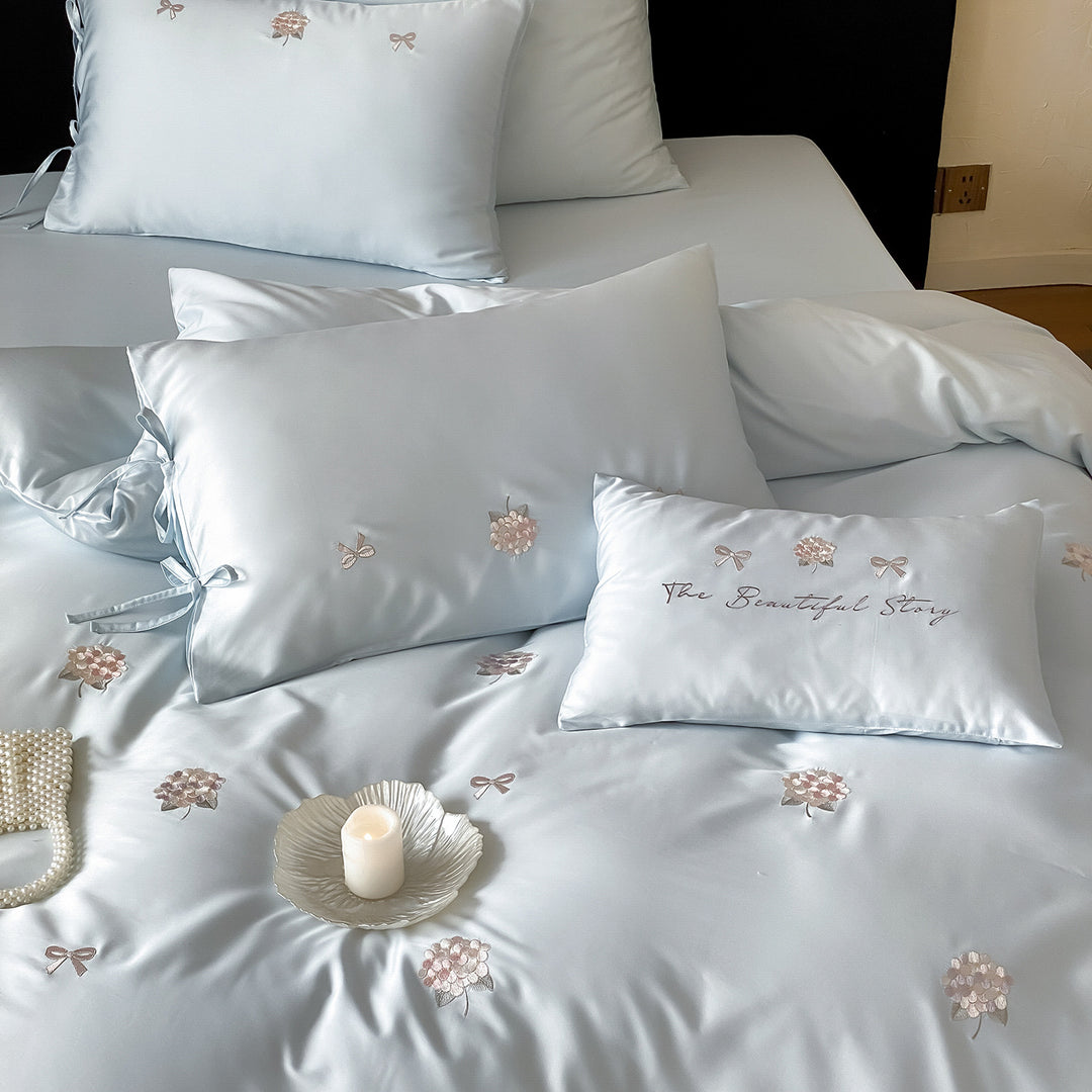 Cotton satin bedding set with delicate bow and flower embroidery as well as pillowcases