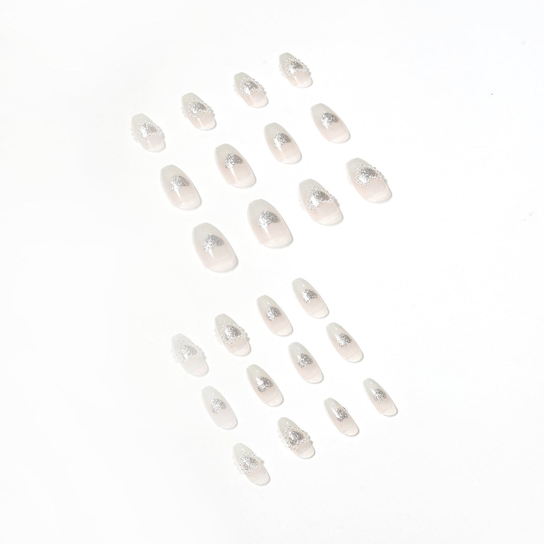 Artificial nail art with heart and rhinestone decorations Stornfield