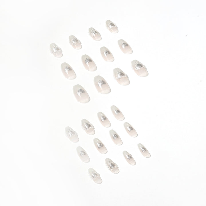 Artificial nail art with heart and rhinestone decorations Stornfield