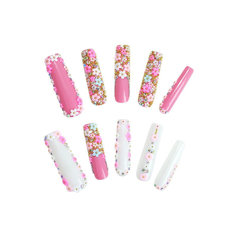 Artificial nail set with floral decorations and glitter accents Stornfield