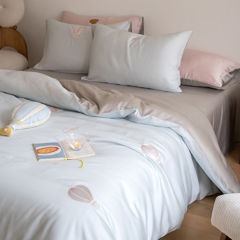 Luxurious satin bedding set with embroidered cherry motifs, reversible function and plush bunny pillow