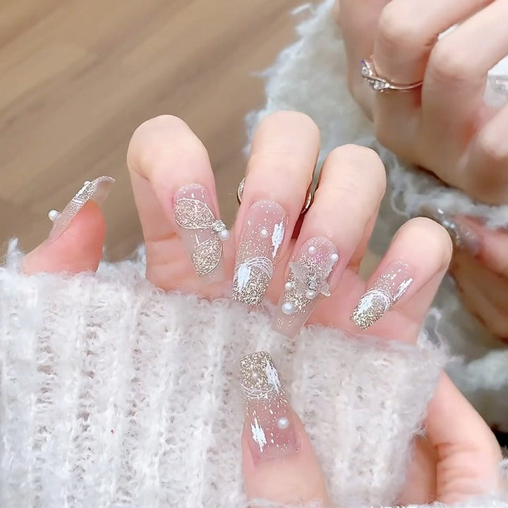 Glamorous artificial nails with heart-shaped accents Stornfield