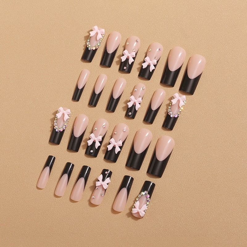 Artificial nails with elegant bows and rhinestone embellishments Stornfield