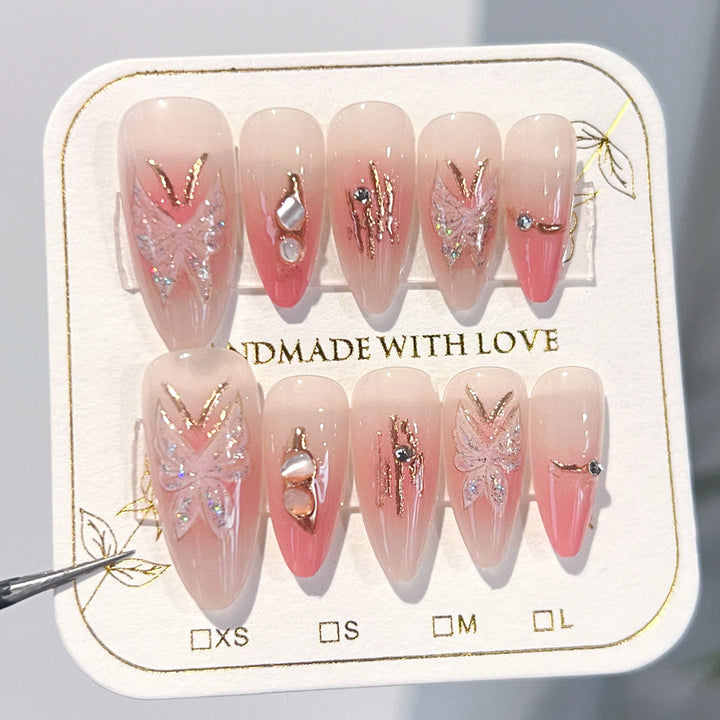 Artificial nail extensions with floral motifs and glitter accents Stornfield
