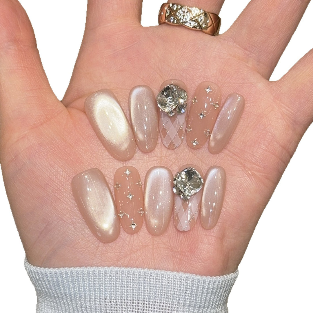 Elegant artificial nails with shimmering effects and rhinestone accents Stornfield