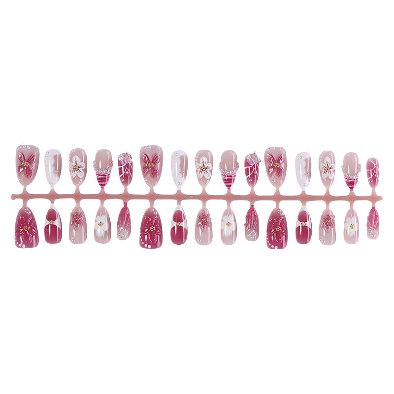 Creative acrylic nail set with floral accents and glitter decorations Stornfield