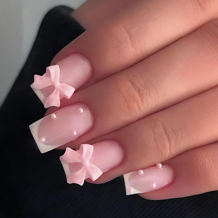 Glamorous artificial nail set with elegant bows and glitter accents Stornfield
