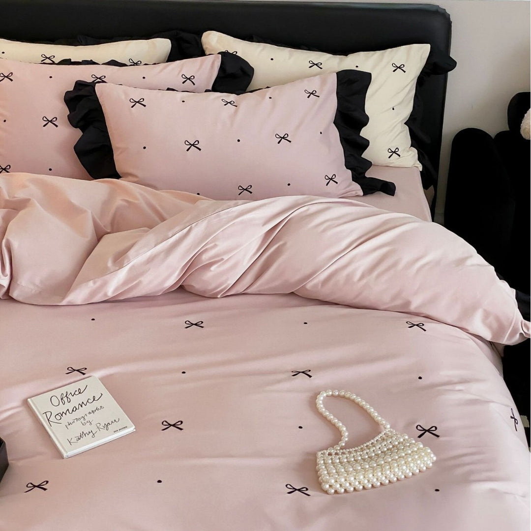 Reversible cotton satin bedding set with fine bow embroidery and ruffled edge