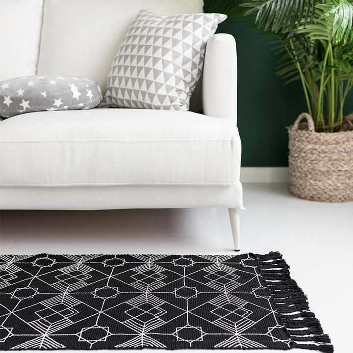 Flat-woven cotton table runner in Art Deco geometry jacquard with hand-fringed edge