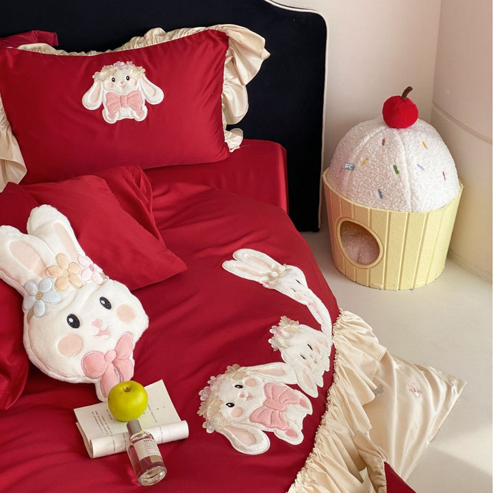 Playful bedding set with ruffles, three-dimensional appliqués, and delicate embroidery