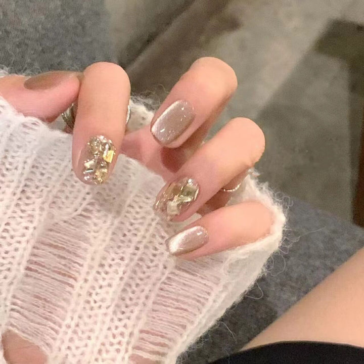 Artificial nail set with elegant glitter pattern and golden accents Stornfield