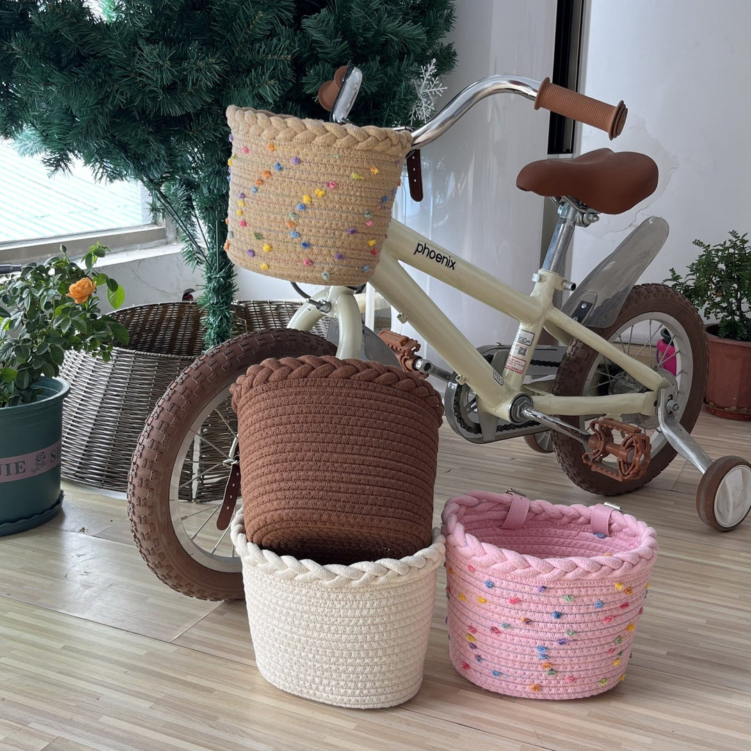 braided rope bike basket with pom pom embellishments and leather handlebar straps Stornfield