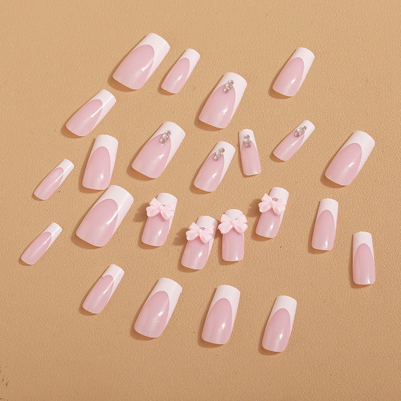 Trendy French-design artificial nails with bow accents Stornfield