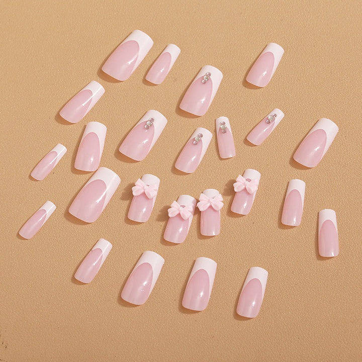 Trendy French-design artificial nails with bow accents Stornfield