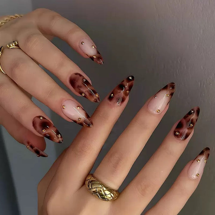 Acrylic nail set with luxurious leopard pattern and golden accents Stornfield