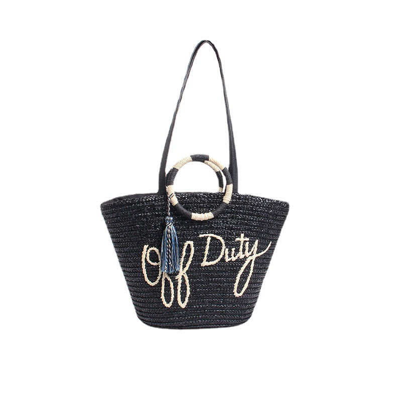 Designer shoulder bag with playful lettering and decorative tassel detail Stornfield