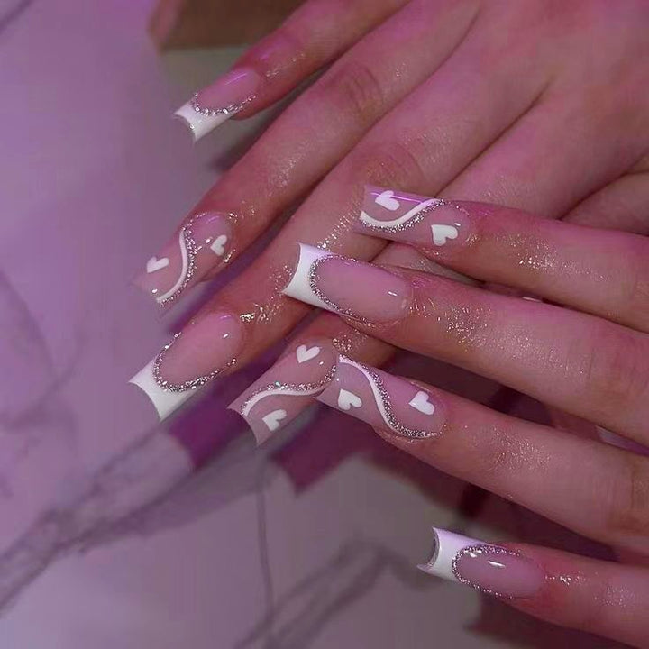 Artificial nail set with romantic heart design and glitter accents Stornfield