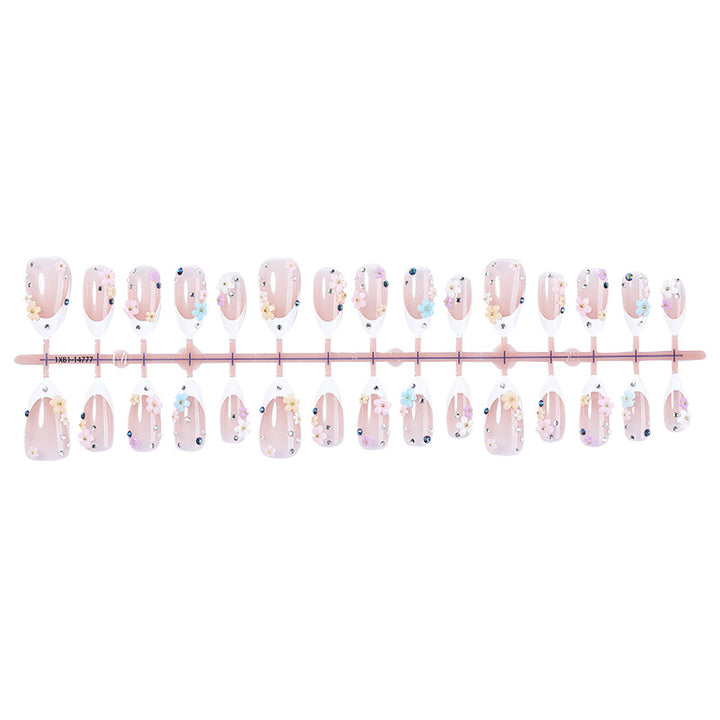 Artificial nail set with delicate floral decorations and sparkling rhinestones Stornfield