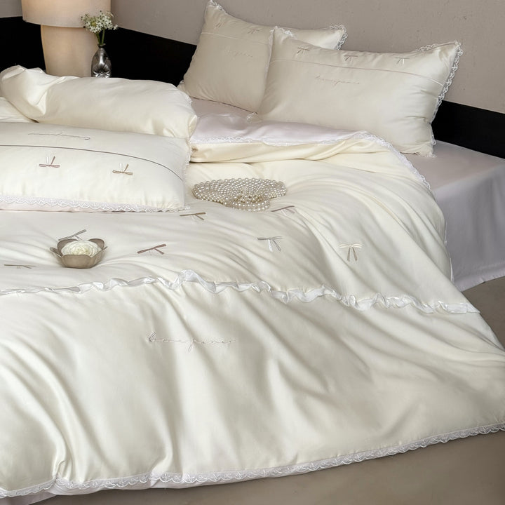 Elegant bedding set made of silky fine satin with embroidered bows and lace trim