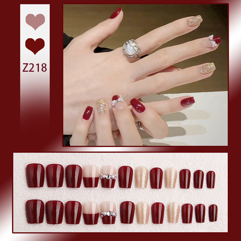 Glamorous artificial nails with glitter and pearl decorations Stornfield