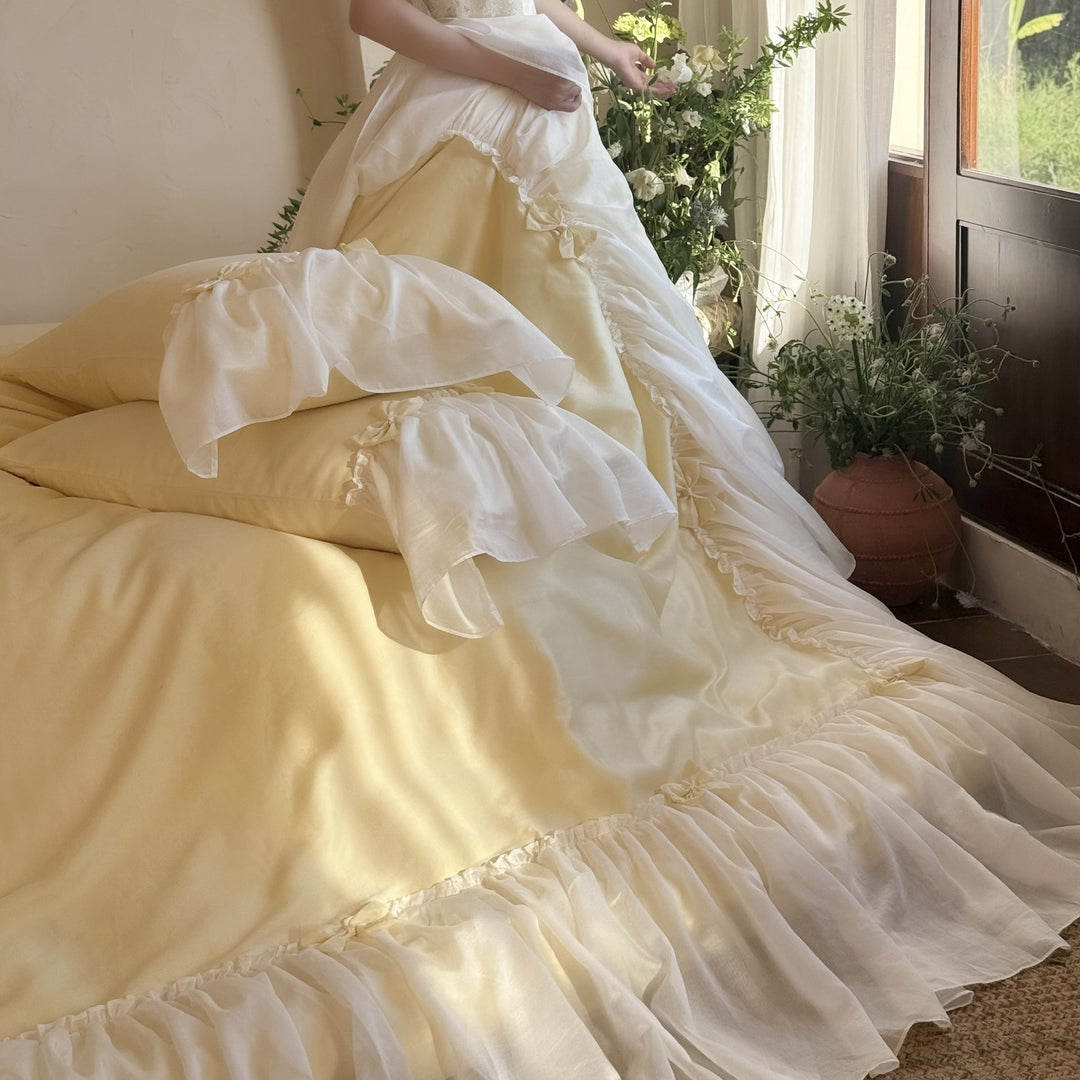 Bedding set with ruffled bed skirt, ruffle cushion and bow application